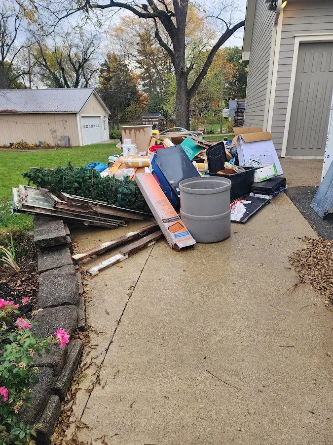 Dumpster being loaded with debris for Estate Cleanout Dumpster Rental in Cortland